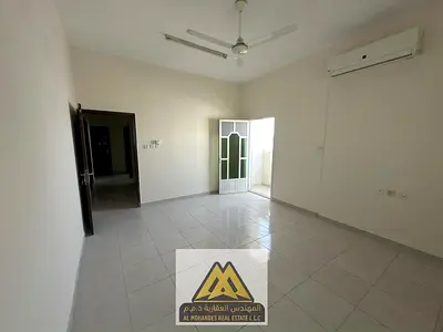 Annual apartment for rent in Al Rawda 1, Ajman. Two bedrooms with a separate living room, 2 external bathrooms, balcony, split A/C, near Dubai exit an
