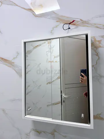 Wall-mounted mirrored bathroom cabinet with sliding glass doors