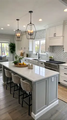 Modern white kitchen with large island and pendant lights