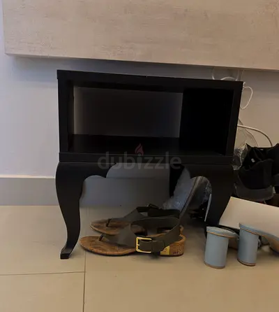 Short black single shelf with curved legs