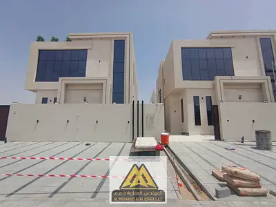 A villa is available for sale in Al Helio, Ajman, featuring a modern design and spacious layout, id