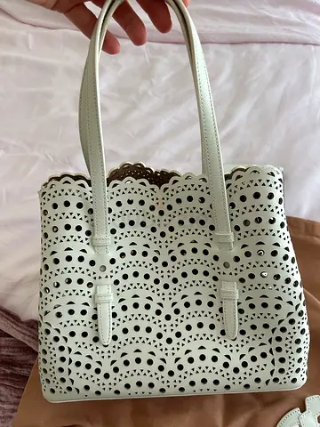 Alaïa Mina 25 tote in white Vienne laser-cut calfskin.