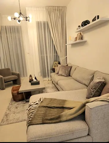 Light grey L-shaped sofa with chaise in good condition