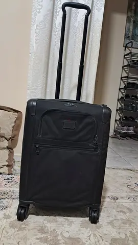 Tumi black soft-shell carry-on suitcase with wheels and telescopic handle