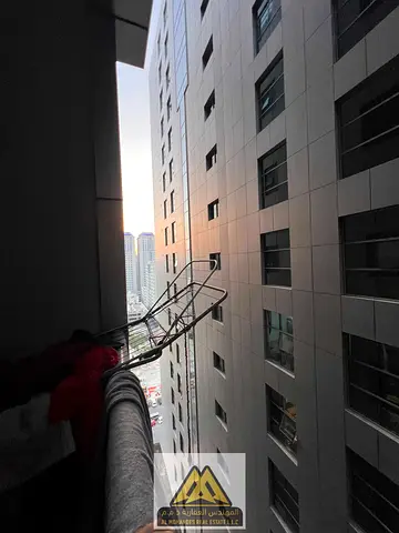 For sale: Two bedrooms, a living room, a balcony with a side view, and parking in City Towers, Al Nuaimiya 3, opposite Grand Mall