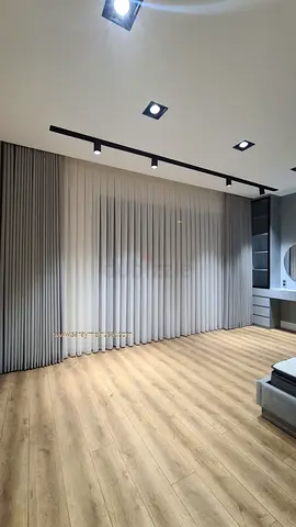 Full-length neutral fabric curtains with blackout lining