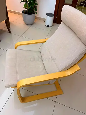 Light wood frame beige lounge chair with cushion. 2 chairs each aed 200 priced reduced