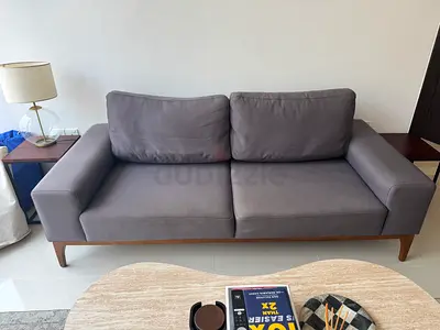 Grey 3-seater fabric sofa with wooden base - good condition