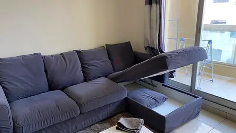 L-shaped grey fabric sofa with storage - good condition