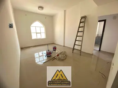 For rent: Brand new 1-bedroom apartment in Al Alia, Ajman, balcony, 2 bathrooms, central AC, free maintenance, prime location.