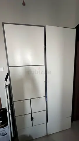 White freestanding wardrobe with multiple compartments - good condition