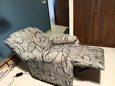Electric Single Recliner Armchair - Fabric Upholstered, Light Grey Patterned .Covered and protected