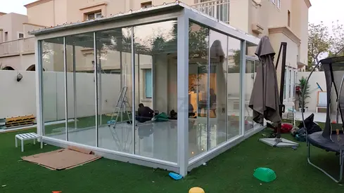 Glass-enclosed outdoor gazebo / sunroom with sliding doors