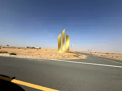 Prime commercial land for sale in Sharjah, Rawdat Al Qurt, second plot from Khorfakkan Street, freeh