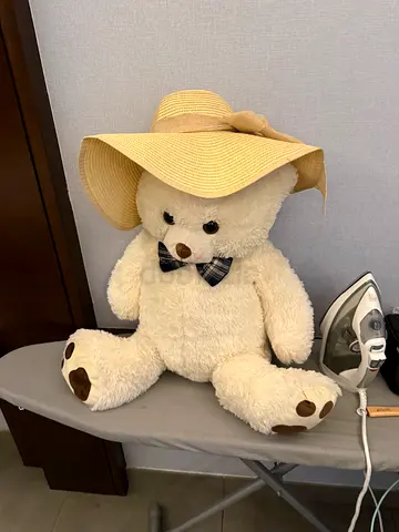 Large beige teddy bear with bow tie and sun hat - gently used