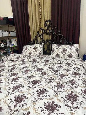 Metal king size bed frame with floral bedding and Bed Sets