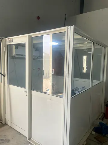 Modular white office partition with glass panels and door