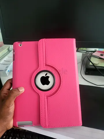 Pink rotating case for iPad with Apple logo cutout