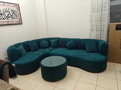 Teal curved modular sofa with ottoman - good condition