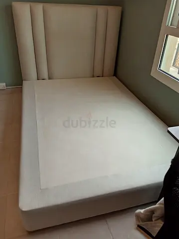 Beige upholstered queen bed frame with padded headboard -  good as like new.. Without mattress.