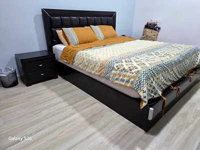 Queen size wooden bed frame with padded headboard and matching bedside table