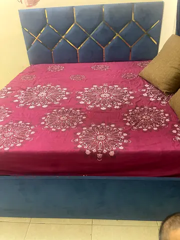 Blue upholstered King size bed with headboard and mattress
