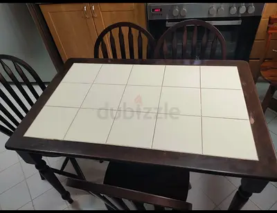 Wooden dining table with white tiled top and 3 chairs