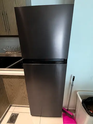Dark stainless top-freezer refrigerator in good condition
