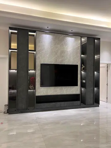 Custom built-in TV entertainment wall unit with shelves and marble panel