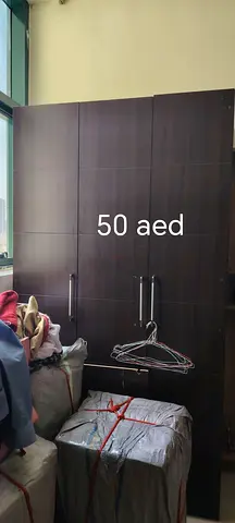 Dark wood 3-door wardrobe with drawers - used, affordable (50 AED)