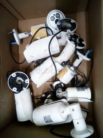 Box of used white outdoor security cameras (for parts or repair)