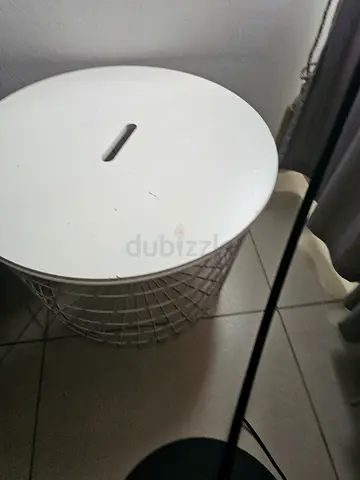 White round metal side table with storage basket top