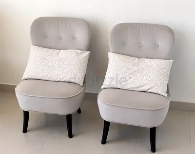 Pair of light grey accent lounge chairs with cushions