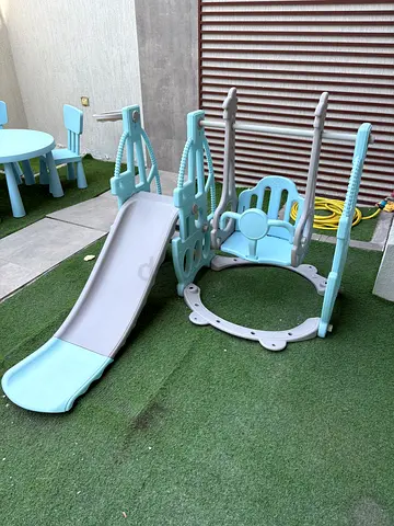 Used outdoor kids playset with slide, swing and activity panels