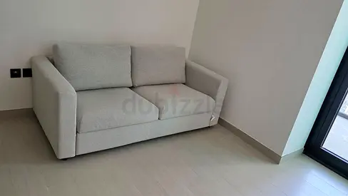 Light grey 2-seater sofa bed in excellent condition