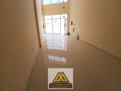 A large shop suitable for all commercial activities in Al-Jarf Industrial Area 2, close to all services and main roads.