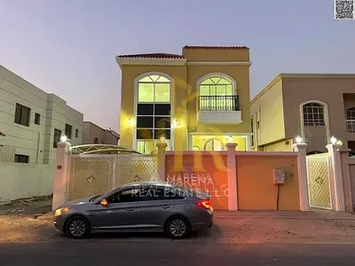 Villa for sale in Ajman – Al Rawda 2 area, prime location on a corner lot (street and alley), price includes electricity, water, and air conditioning,