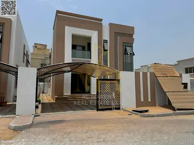 Two-story villa with a rooftop terrace, including electricity, water, and air conditioning, in one of Ajman's most prestigious areas. Freehold ownersh