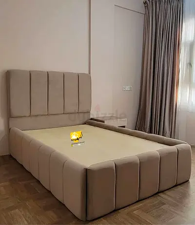 Beige upholstered double bed with padded headboard (good condition)