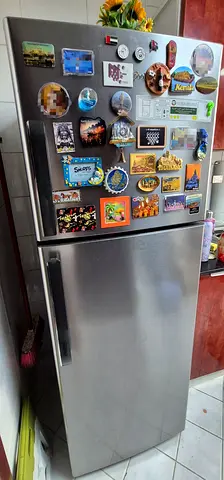 Moving Out Sale: Silver two-door refrigerator 323 Ltr in good working condition, without magnets