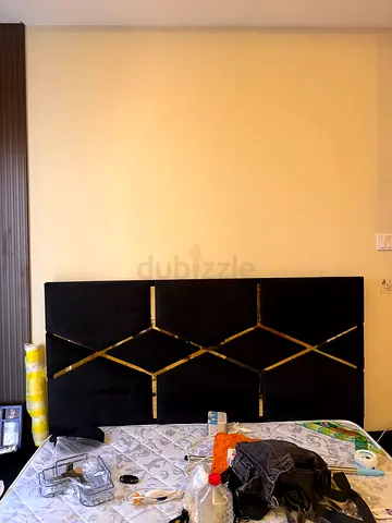 King-size upholstered black headboard with gold trim — good condition