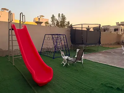 Outdoor kids playset: slide, climbing frame and trampoline