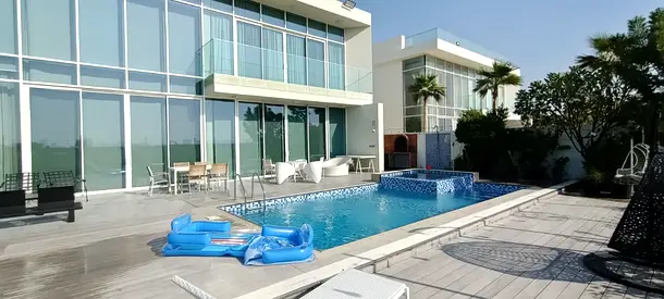 Villa for sale in Al Zorah, Ajman, featuring a view of the golf courses and a private swimming pool