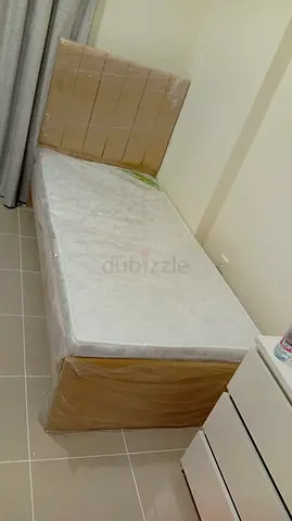 Single bed with mattress and headboard — almost new, still wrapped