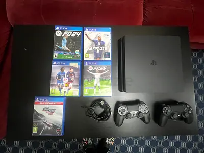 Sony PlayStation 4 Slim Bundle with 2 Controllers and 5 Games and FIFA 2026 online installed.