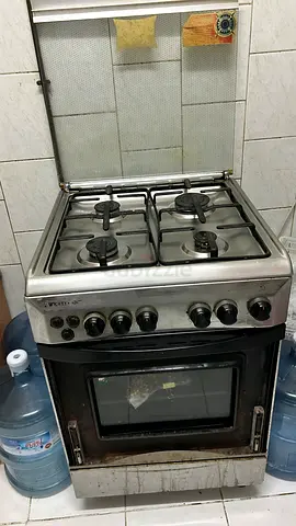 Used freestanding stainless steel gas oven with 4-burner hob - working condition