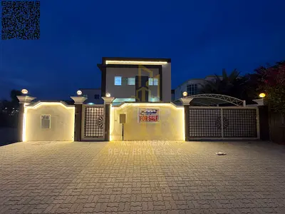 Two-story villa with a rooftop terrace, including electricity, water, and air conditioning, in one of Ajman's most prestigious areas. Freehold ownersh