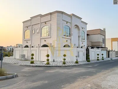 Corner villa in Al Aaliyah, two floors and a roof, ready to move in, price includes electricity, water and air conditioning fees, on the main street,