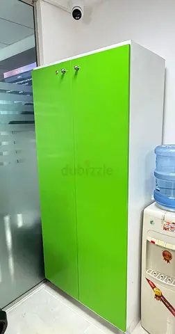 Green and white 4-door storage cabinet - good condition