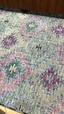 Used patterned area rug — geometric pastel design, good condition